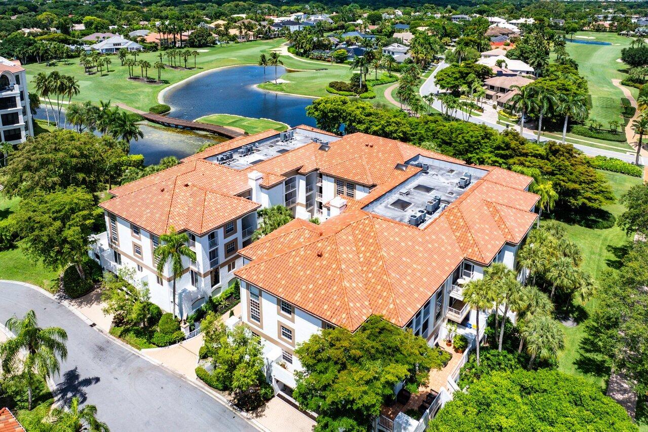 Aerial view of Orangewood Lane condominiums beside a pond and golf course.