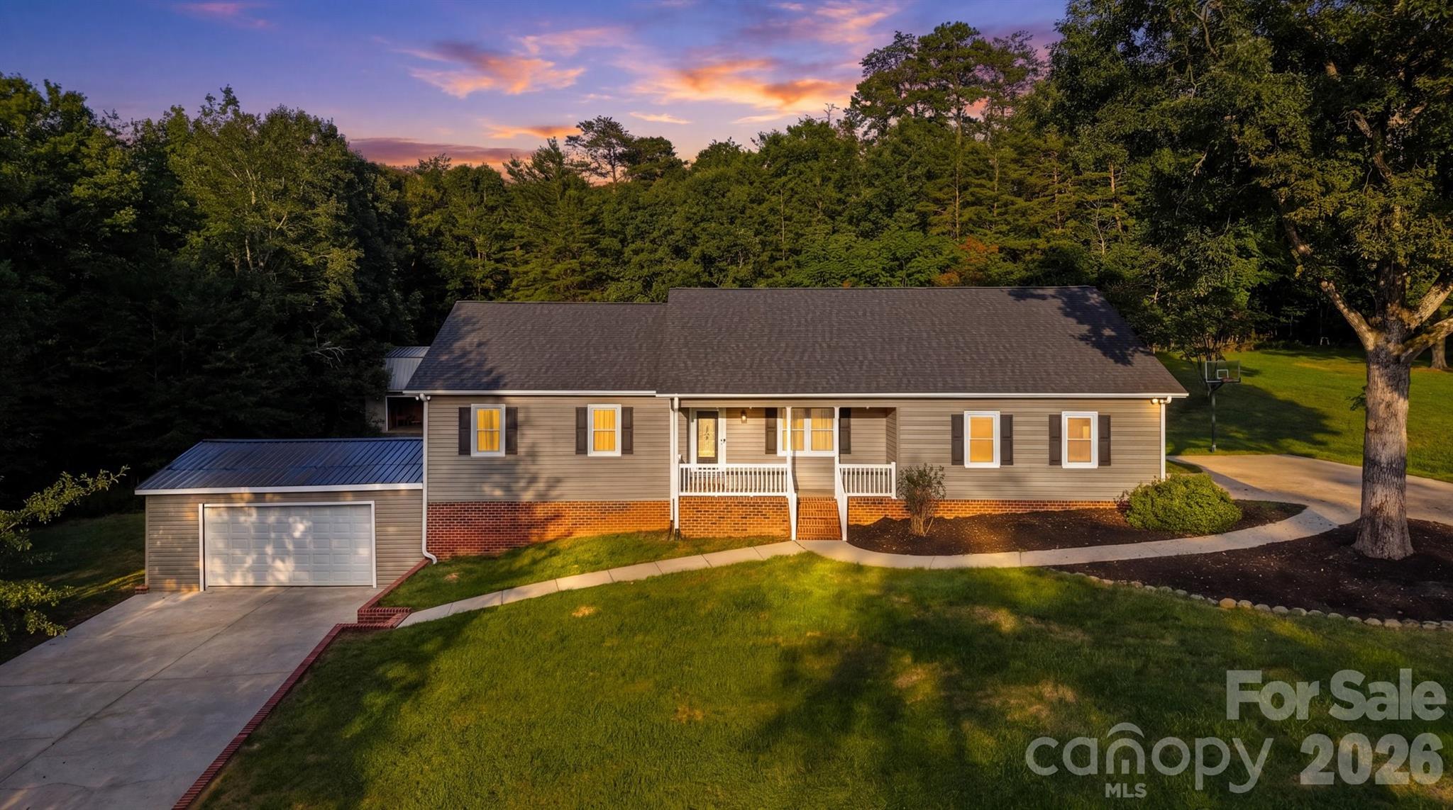 136 Cook Lane home with an attached garage and covered porch, photographed at sunset.