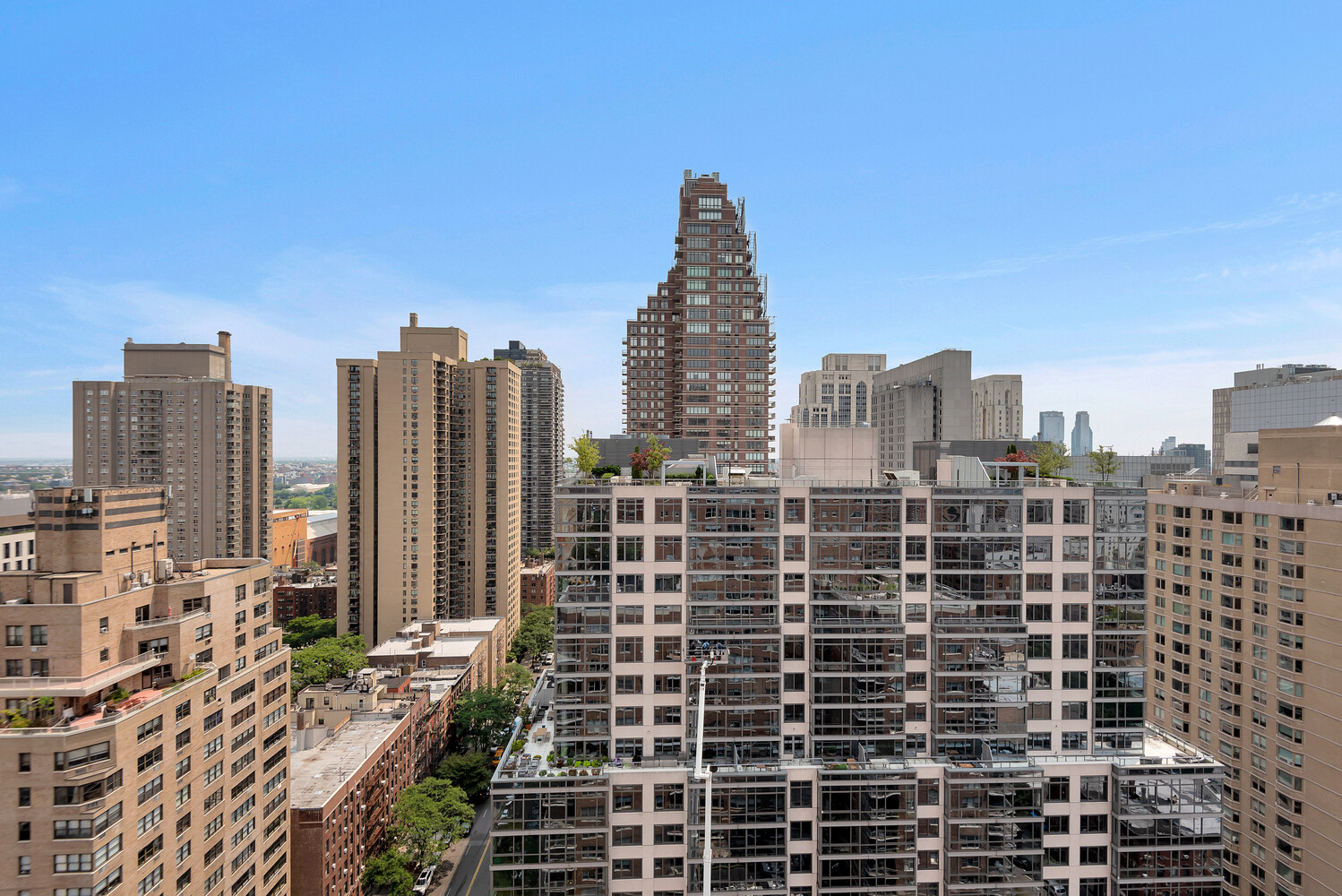 Upper East Side skyline with a distinctive stepped high-rise among surrounding buildings.