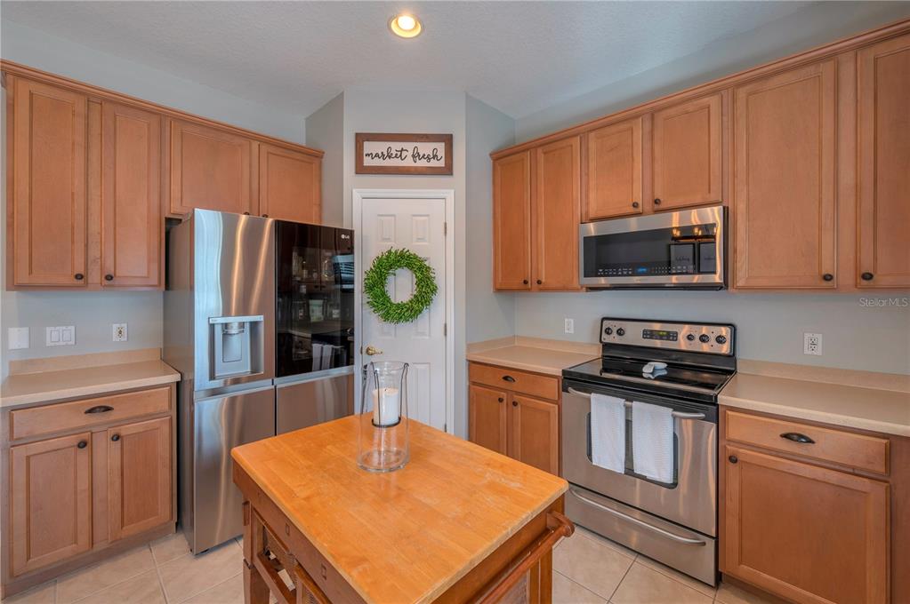 Kitchen with wood cabinets, stainless steel appliances, and a central island.