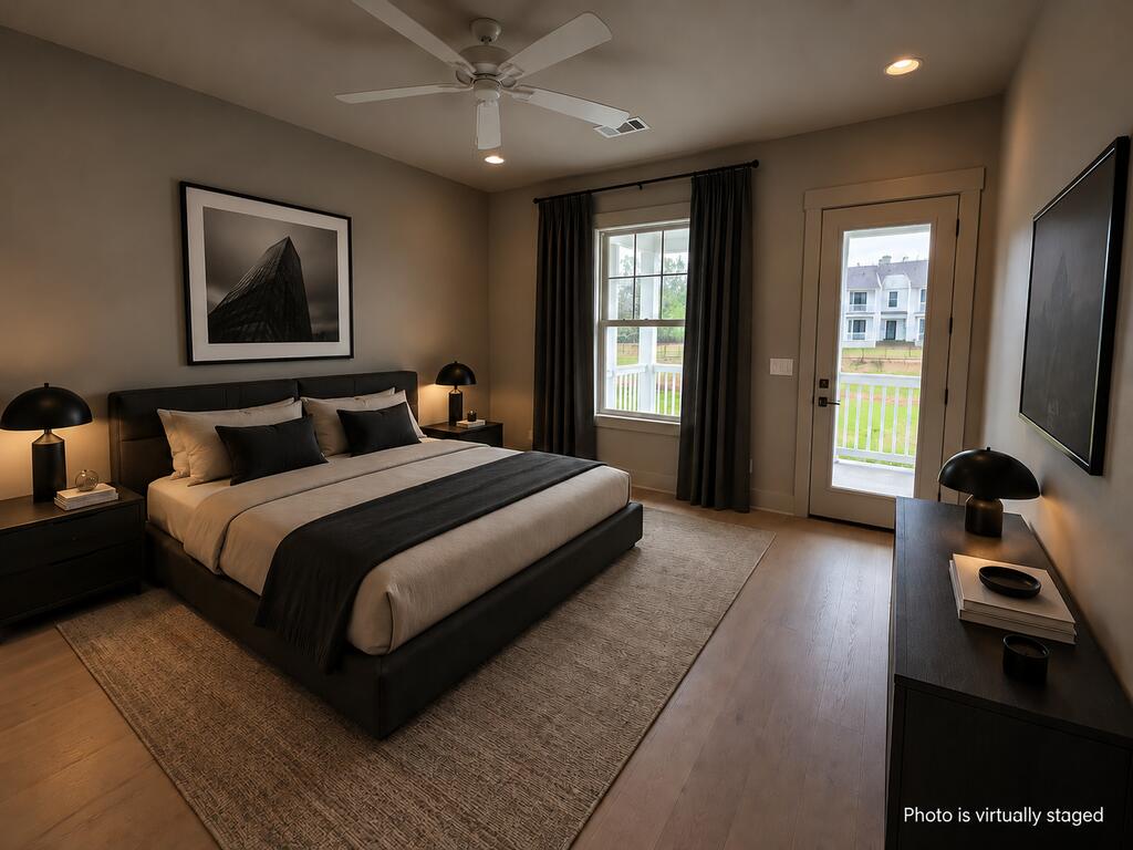 Bedroom with a king-size bed, dark furnishings, and a glass door opening to a balcony.