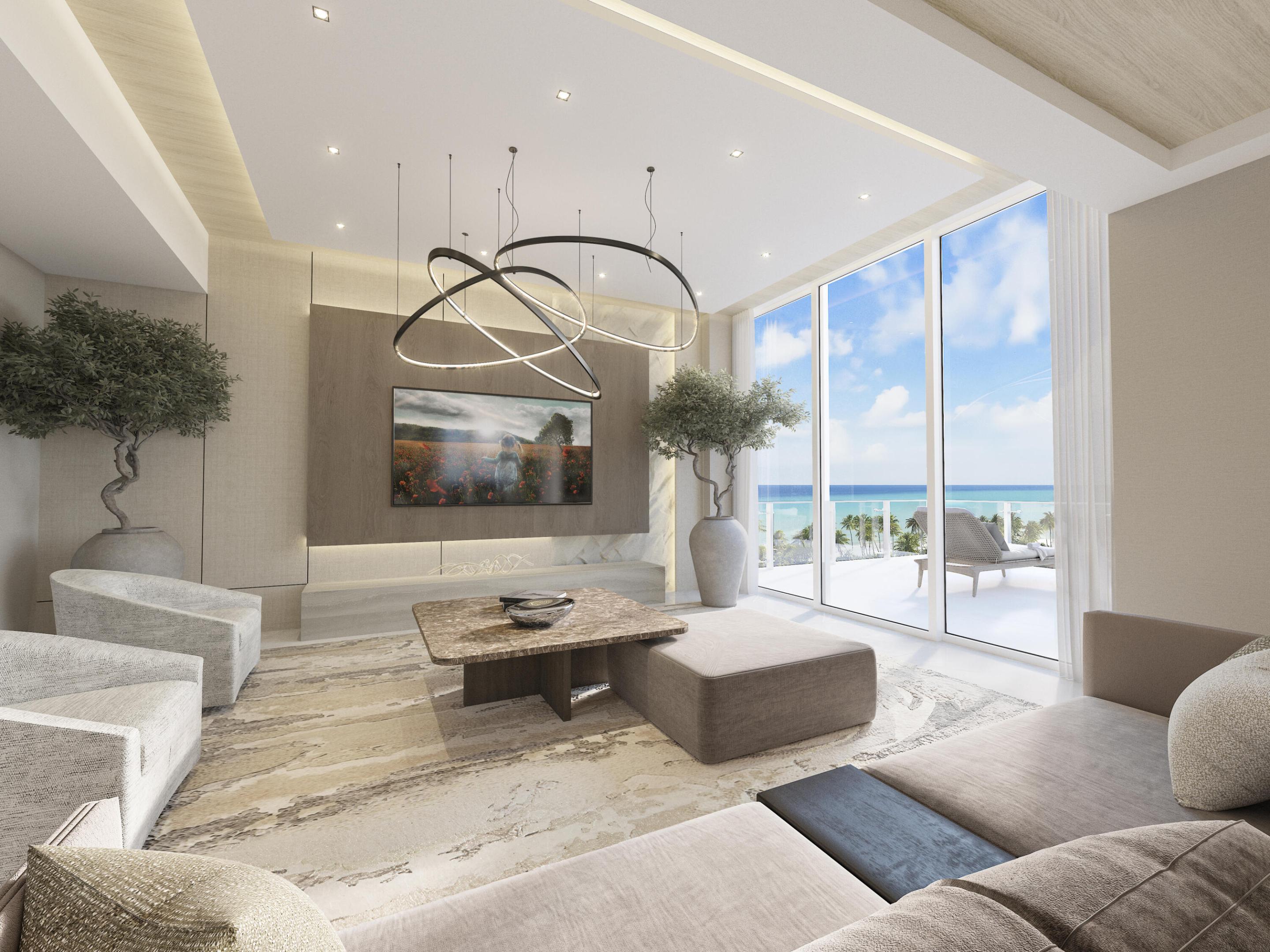 Modern living room with sculptural lighting and floor-to-ceiling ocean-view windows.