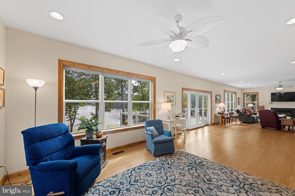 Living room with blue recliners and a large window overlooking the water.