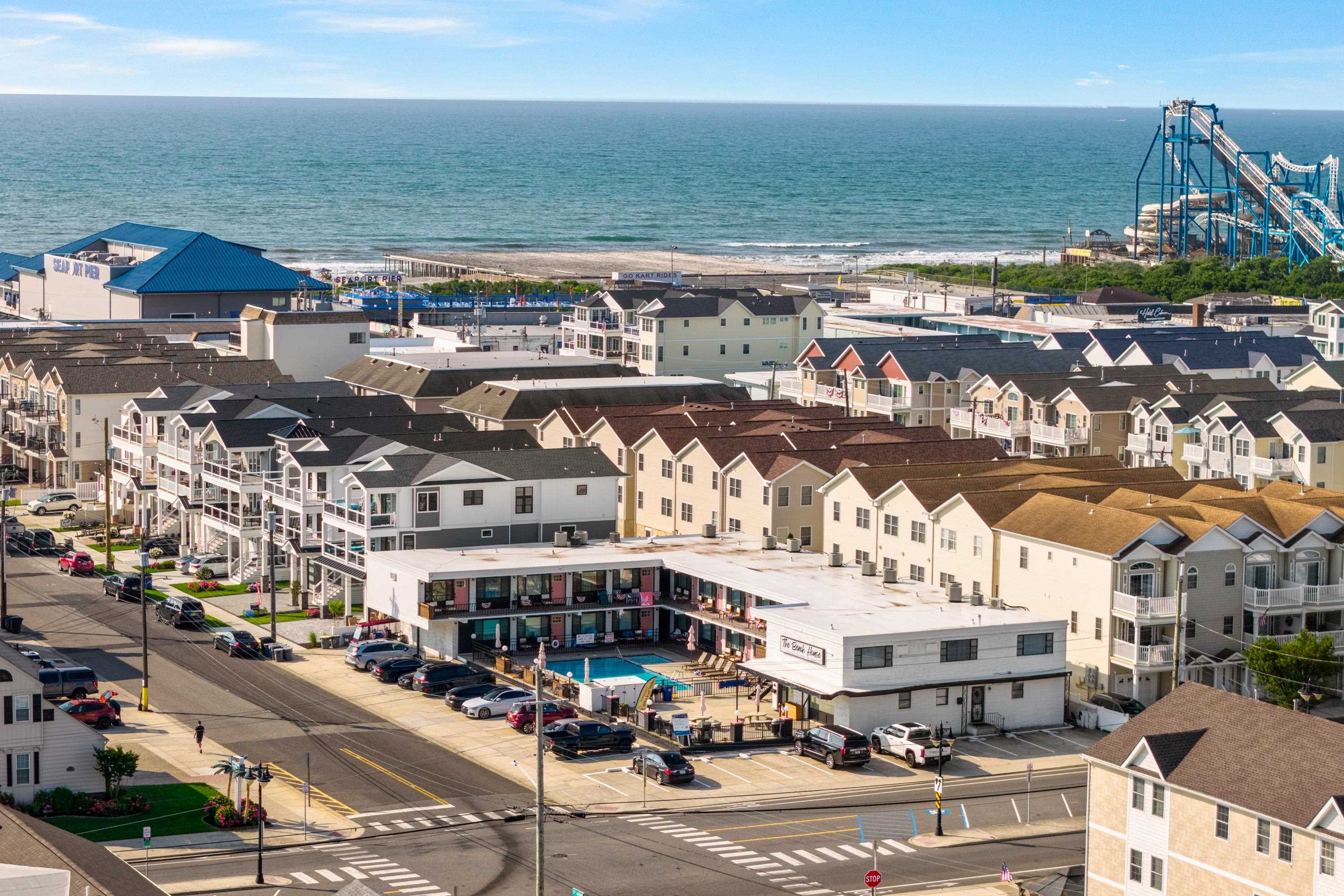 North Wildwood coastal neighborhood with the ocean, Seaport Pier and a pool courtyard.