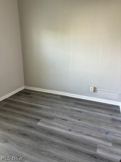 Vacant room with gray wood-look plank flooring and light neutral walls.