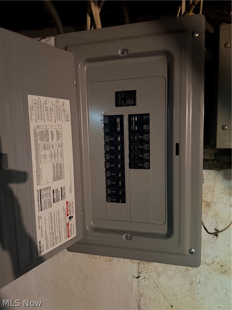 Open Siemens breaker panel with its circuit chart on the inside of the door.
