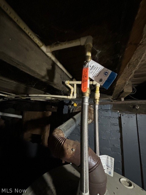 Basement plumbing with shutoff valves, flexible metal lines, and ductwork.