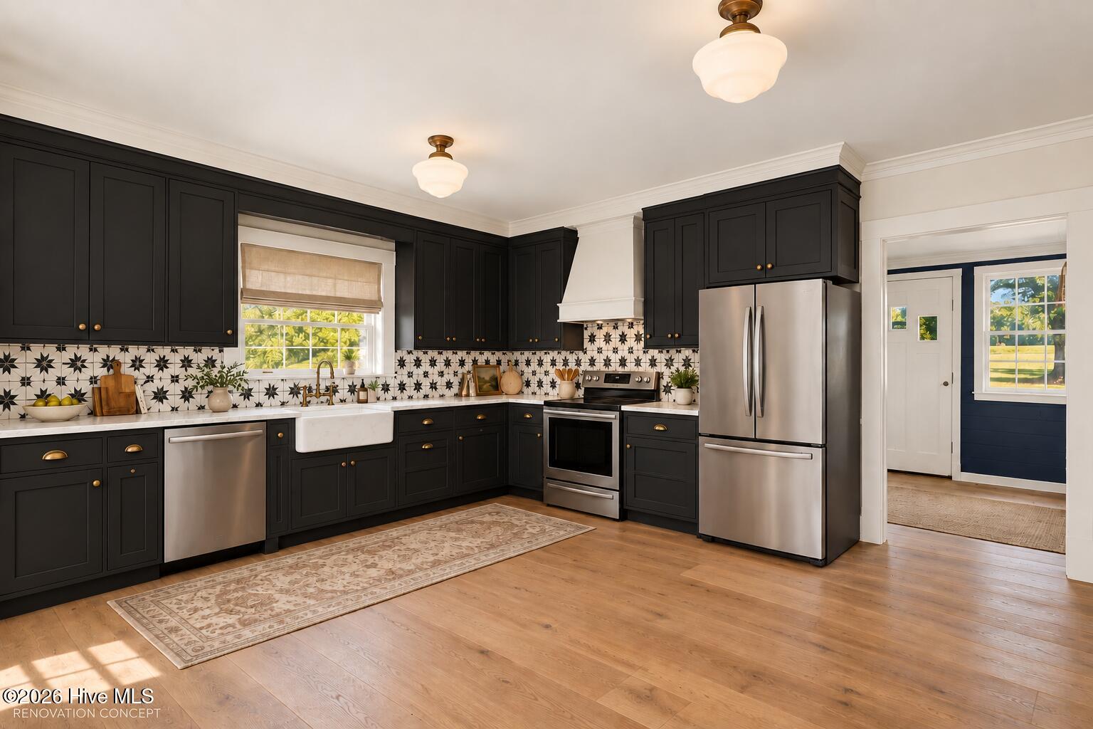 Kitchen with dark cabinets, patterned tile backsplash, farmhouse sink, and stainless steel appliances.