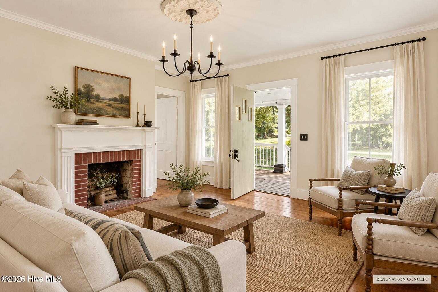 Living room with brick fireplace, light furnishings, and an open door to the porch.