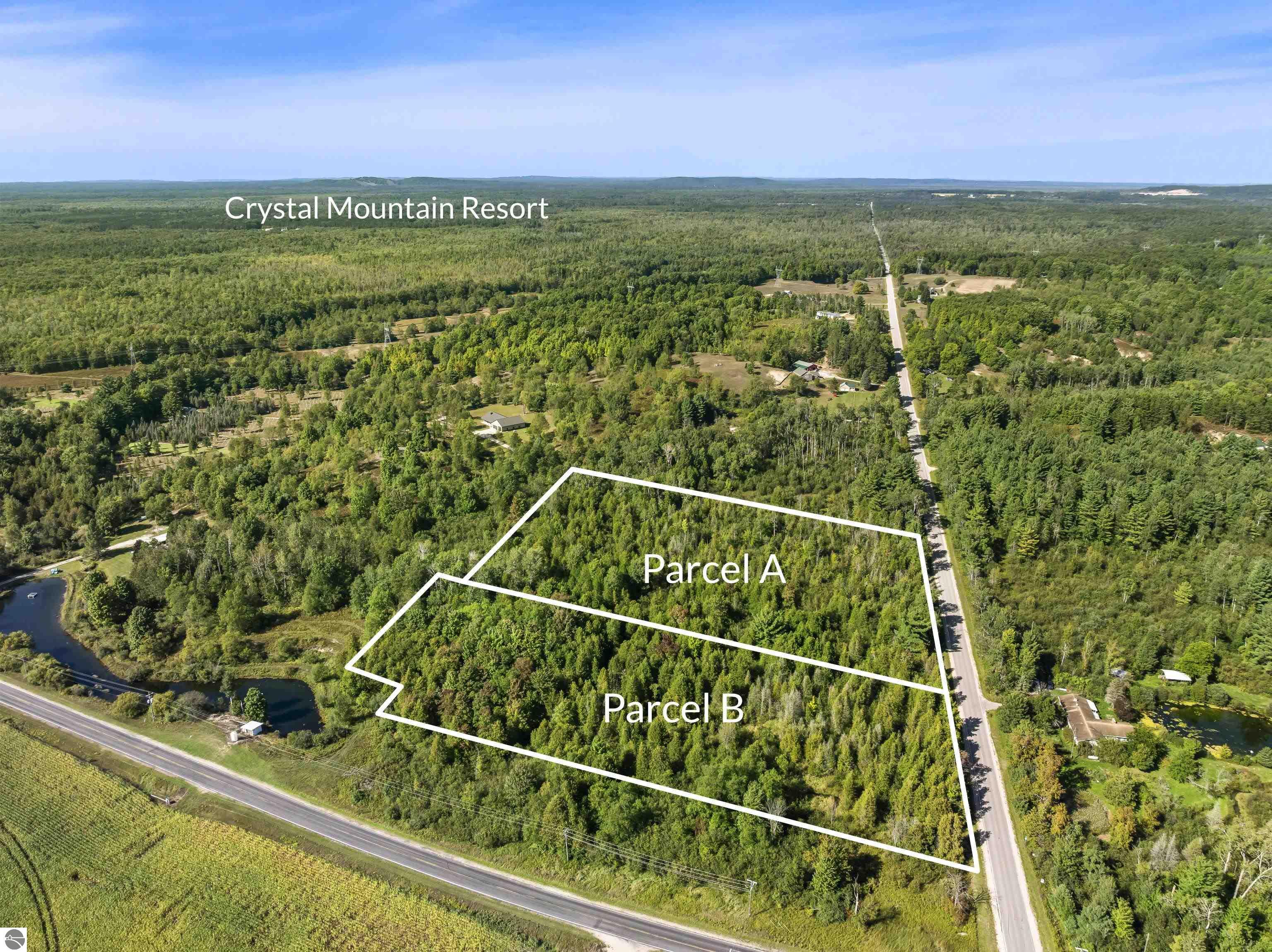 Aerial view of two wooded parcels outlined beside roads near Crystal Mountain Resort.