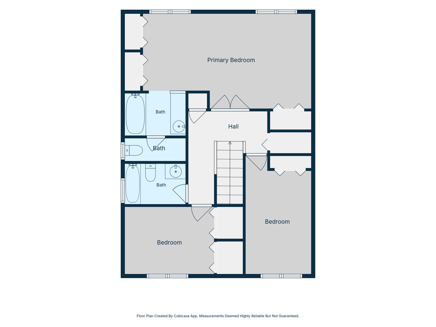 Second-floor plan with a primary bedroom, two bedrooms, three bathrooms, and a central staircase.