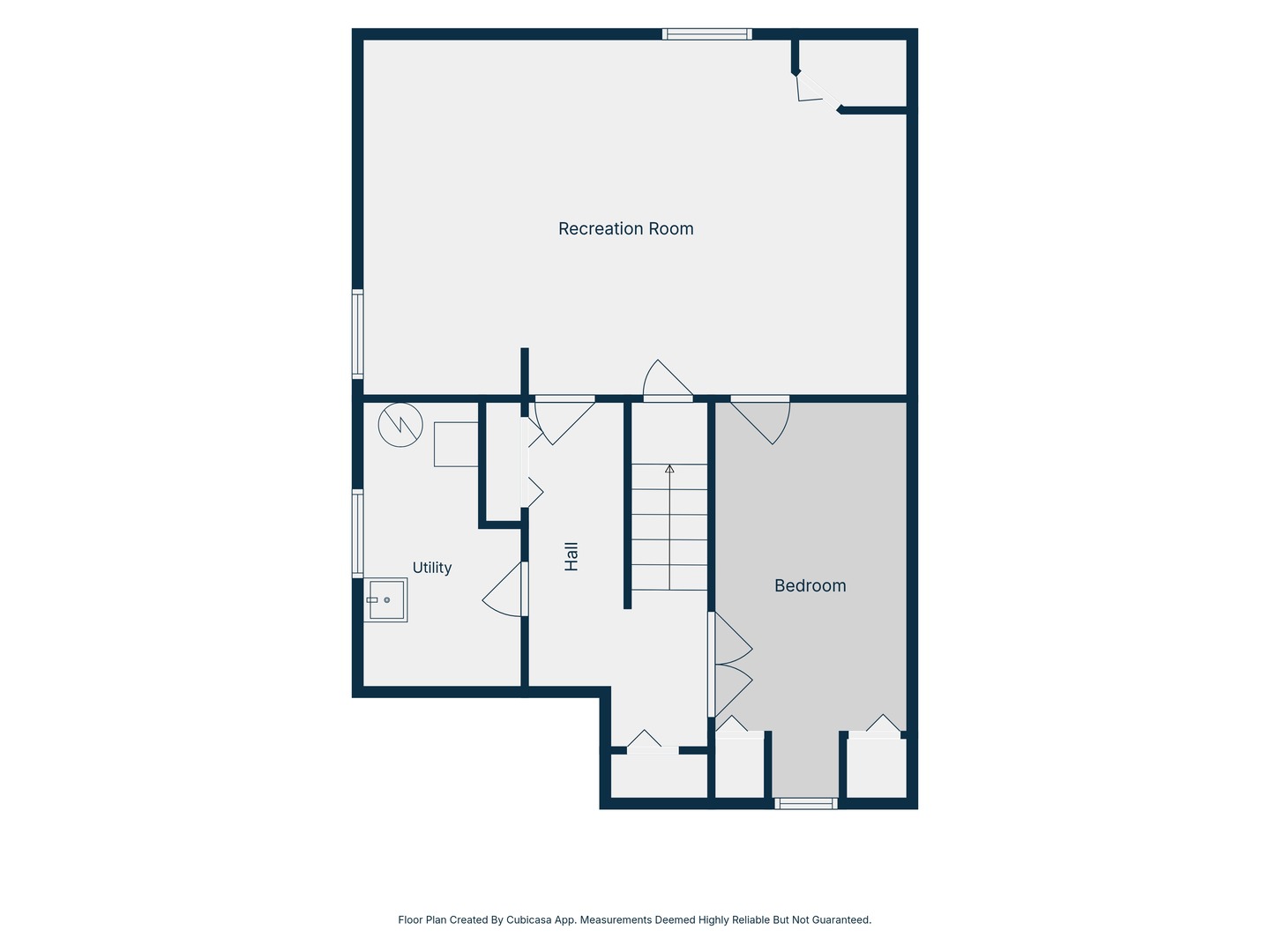 Floor plan showing a recreation room, bedroom, utility room, hall, and staircase.