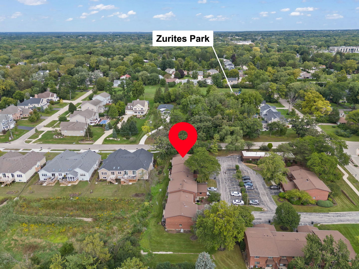 Aerial view of 1221 Geneva Lane marked among homes and trees near Zurites Park.