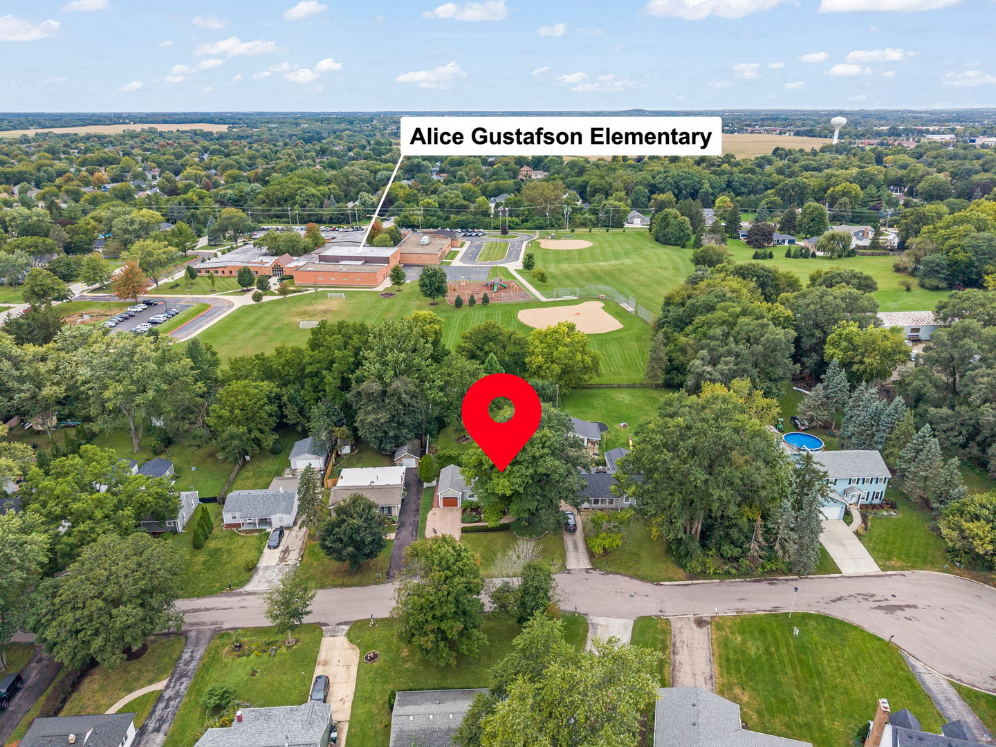 Aerial view of the home’s neighborhood, with Alice Gustafson Elementary and playing fields beyond.