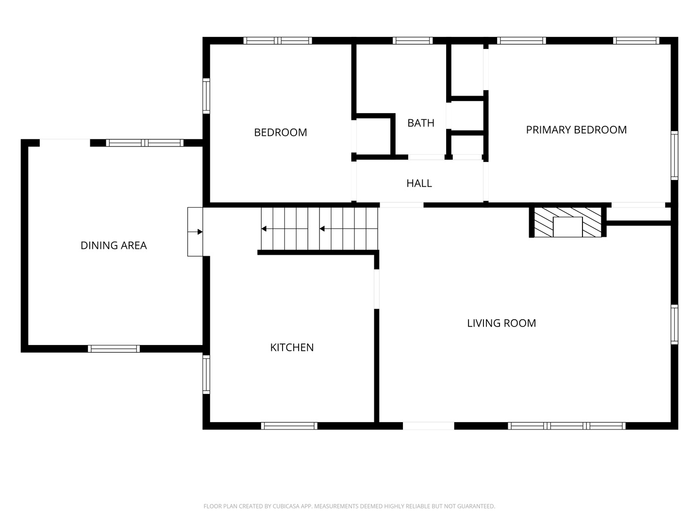 Floor plan with two bedrooms, a bath, dining area, kitchen, living room, and central stairs.