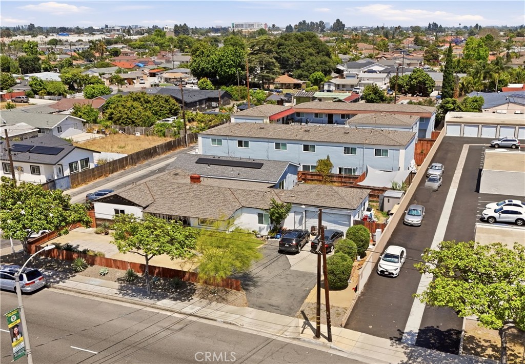 Aerial view of a multifamily property with low-rise buildings and parking areas.