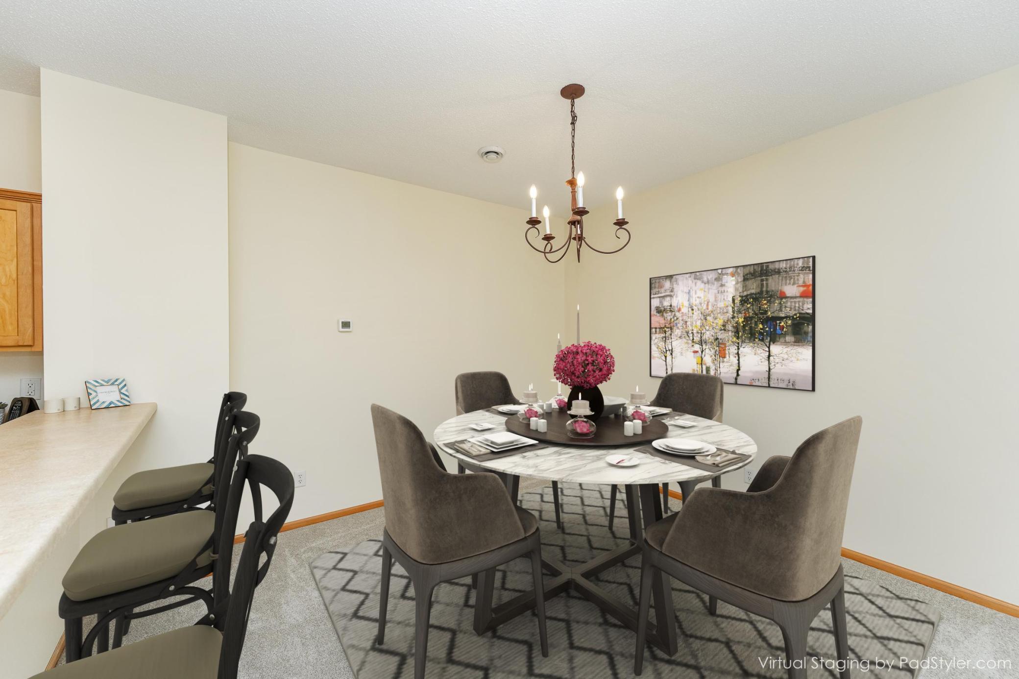 Virtually staged dining room with a set table, upholstered chairs, and a chandelier.