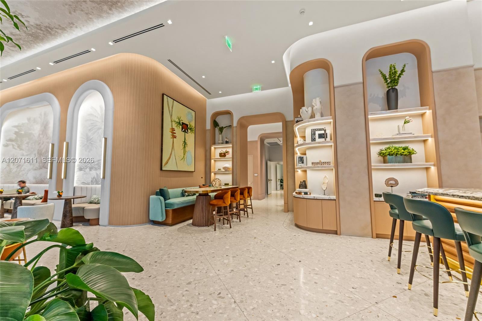 Building lounge with curved wood-paneled walls, illuminated display shelves, and banquette seating