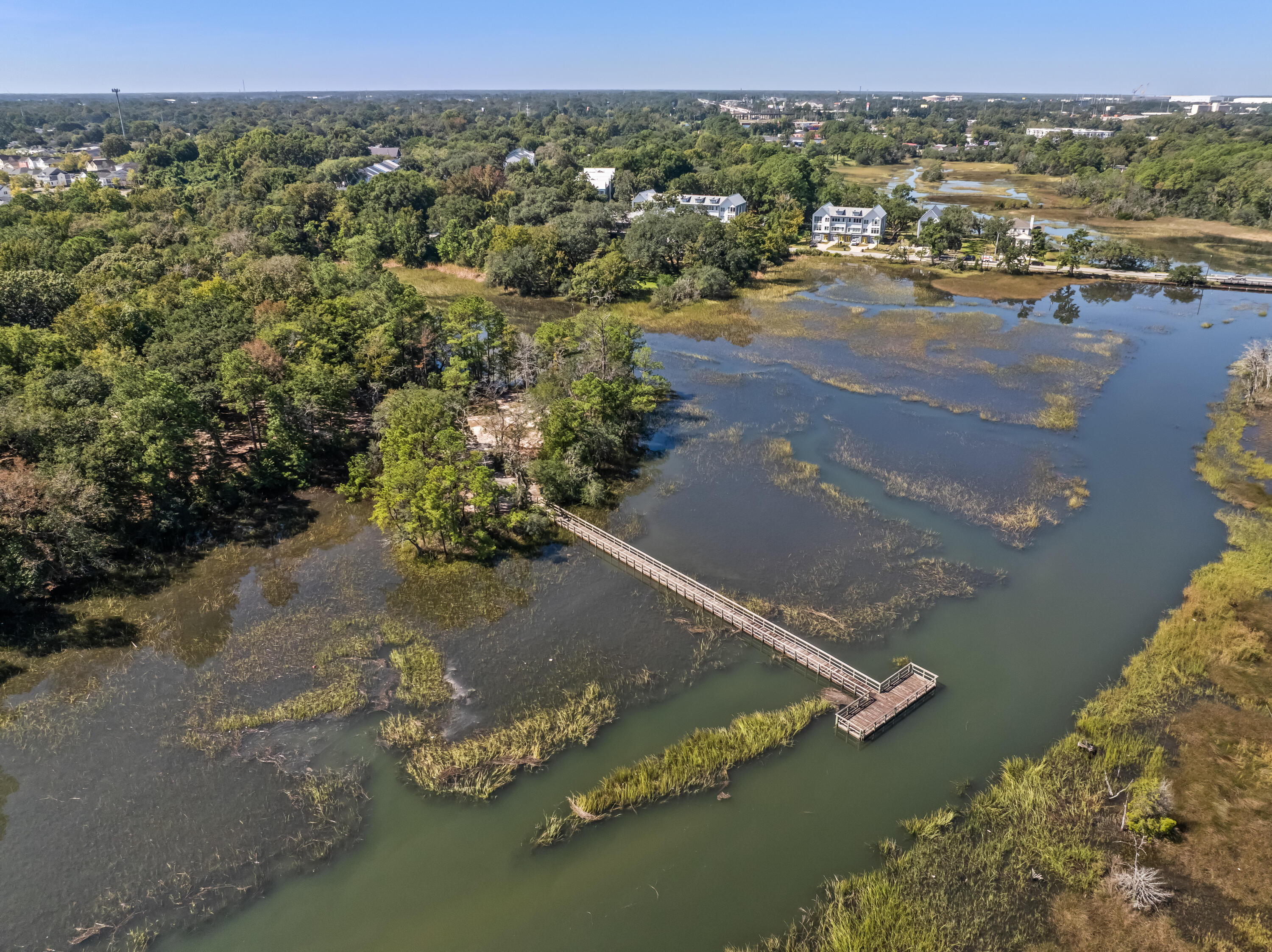 Aerial marsh view with a long boardwalk and viewing platform extending over the water.