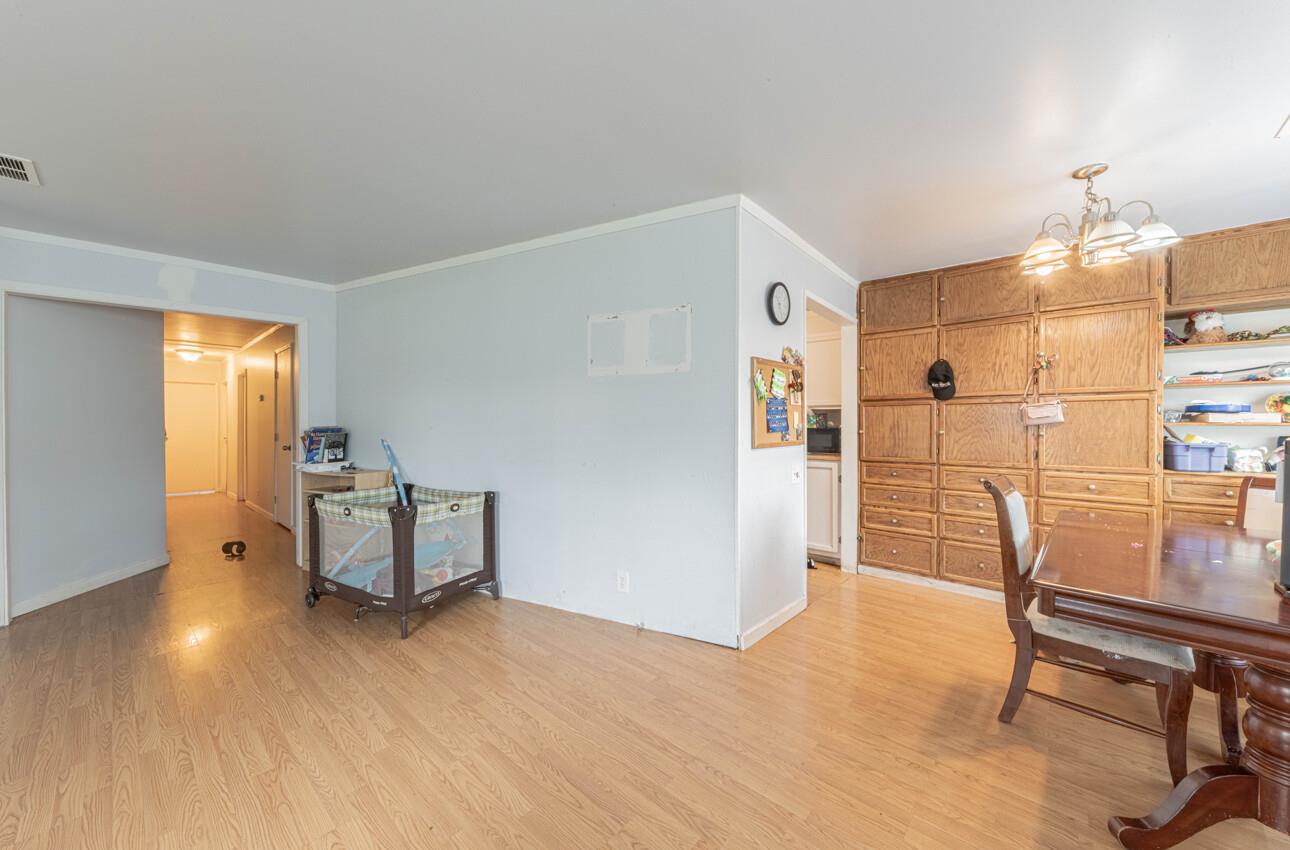 Dining area with built-in wood cabinetry, a wooden table, and light wood flooring.