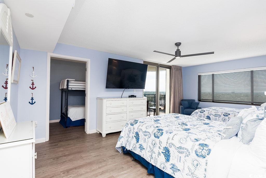 Bedroom with blue-and-white patterned bedding, a bunk-bed alcove, and sliding doors to a balcony.