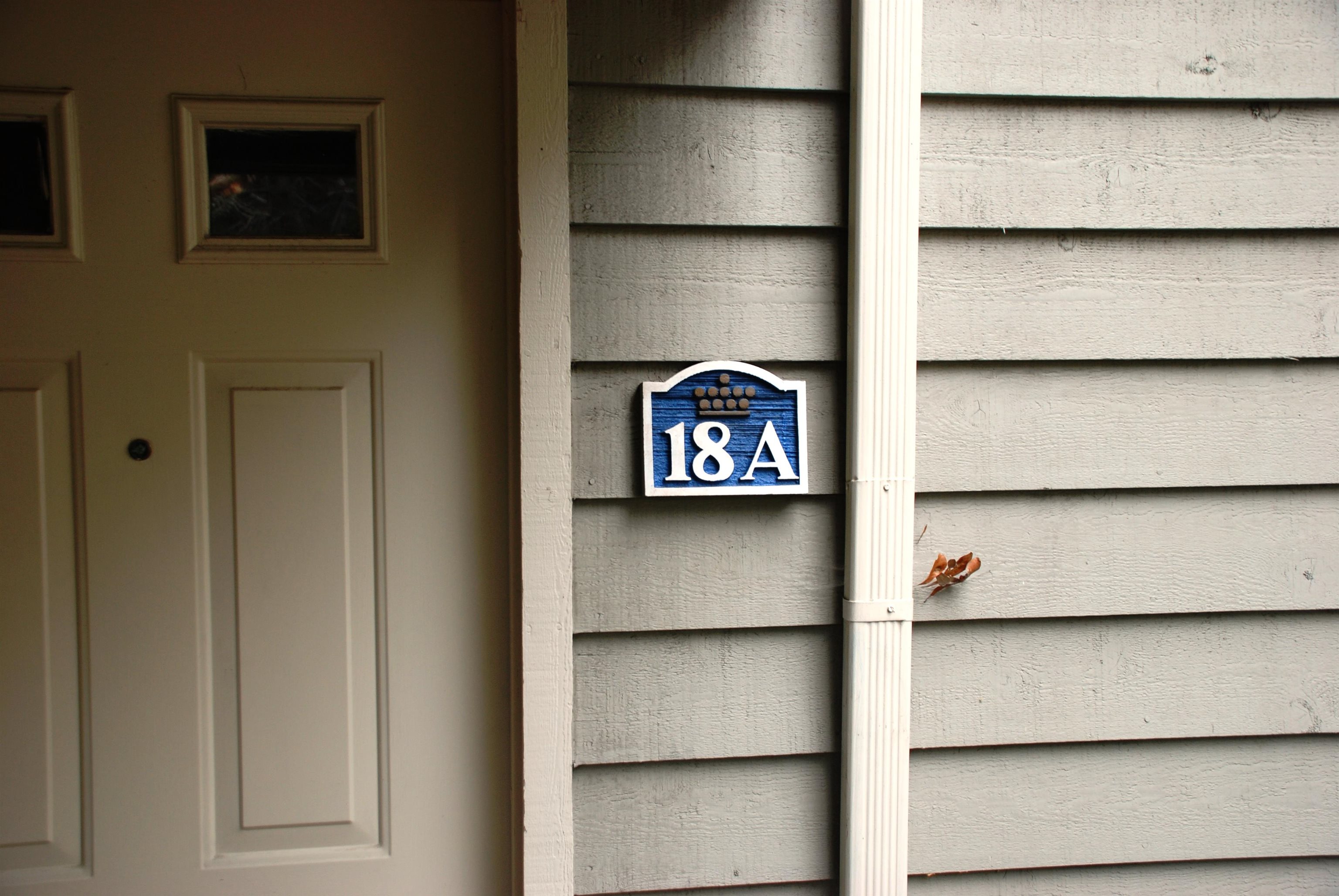 Unit 18A entrance with a blue number plaque beside the front door.