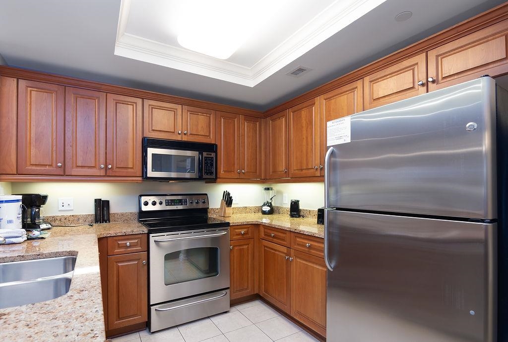 Kitchen with wood cabinets, granite countertops, and stainless steel appliances.