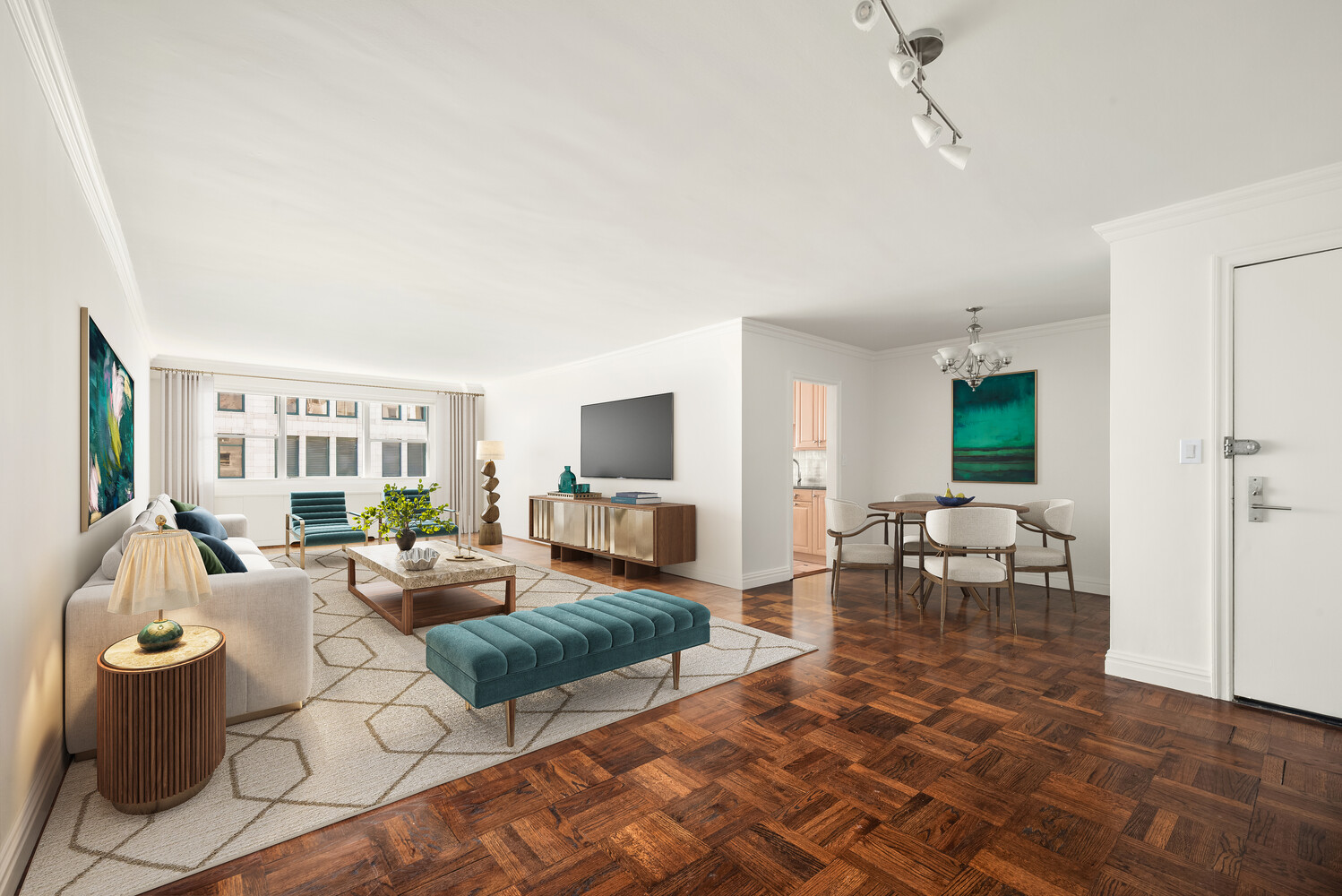 Open-plan living and dining room with parquet floors, large windows, and teal furnishings.