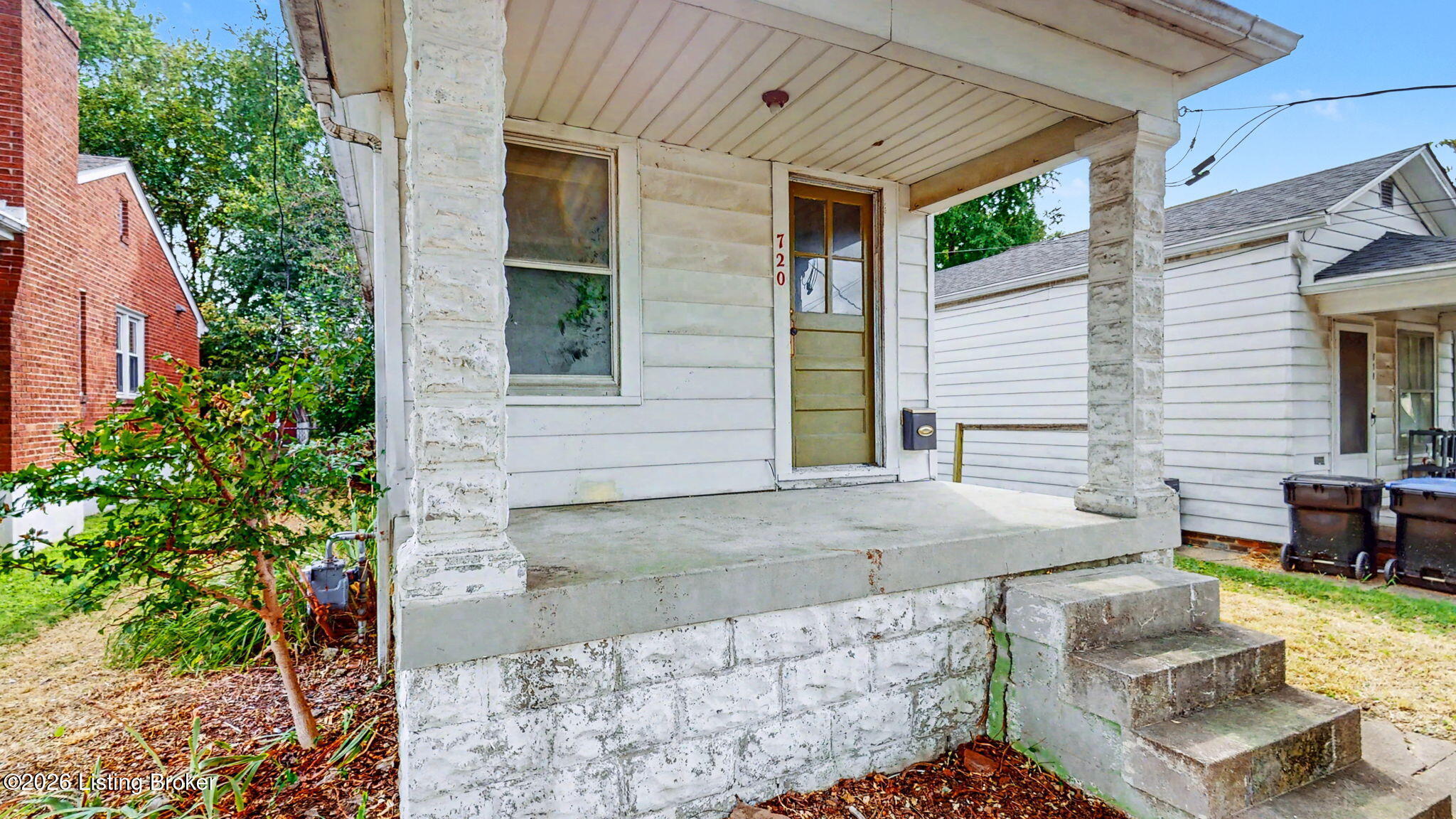 Front porch with stone columns and steps at 720 Shelby Pkwy.