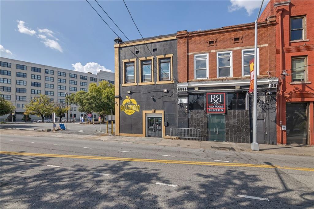 Downtown Atlanta storefronts, including Hollywood and Red Room Bistro, along a sunlit street.