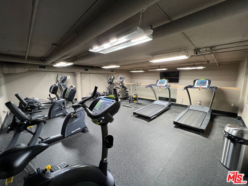 Fitness room with stationary bikes, treadmills, and elliptical machines.