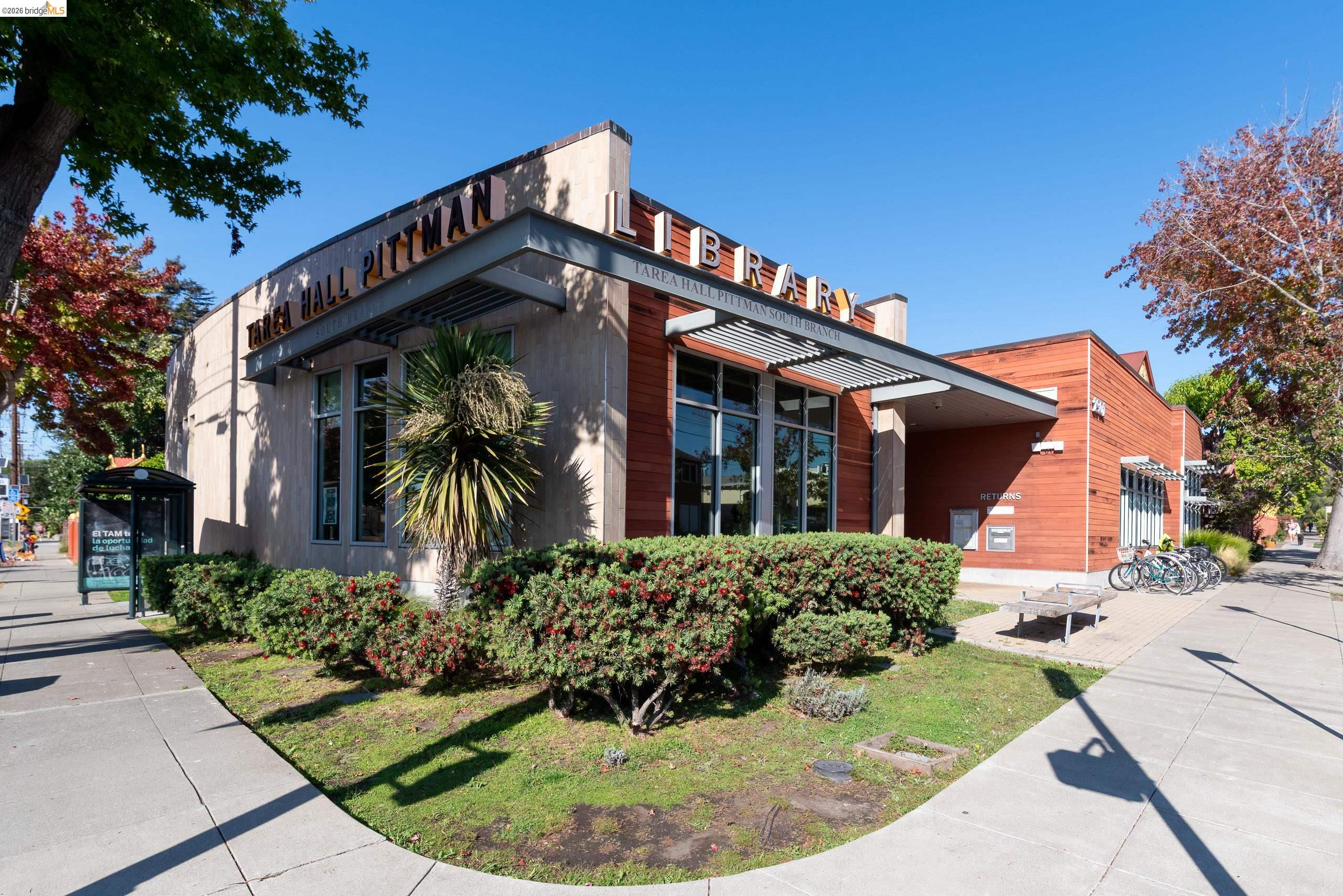 Tarea Hall Pittman South Branch Library with redwood siding, glass windows, and landscaped sidewalk.