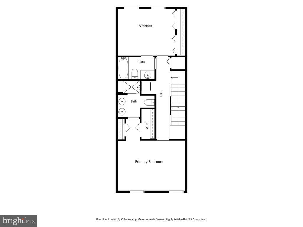 Upper-level floor plan with two bedrooms, two bathrooms, a walk-in closet, and stairs.