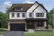 Two-story gray house with a stone-accented facade, front porch, and single-car garage.