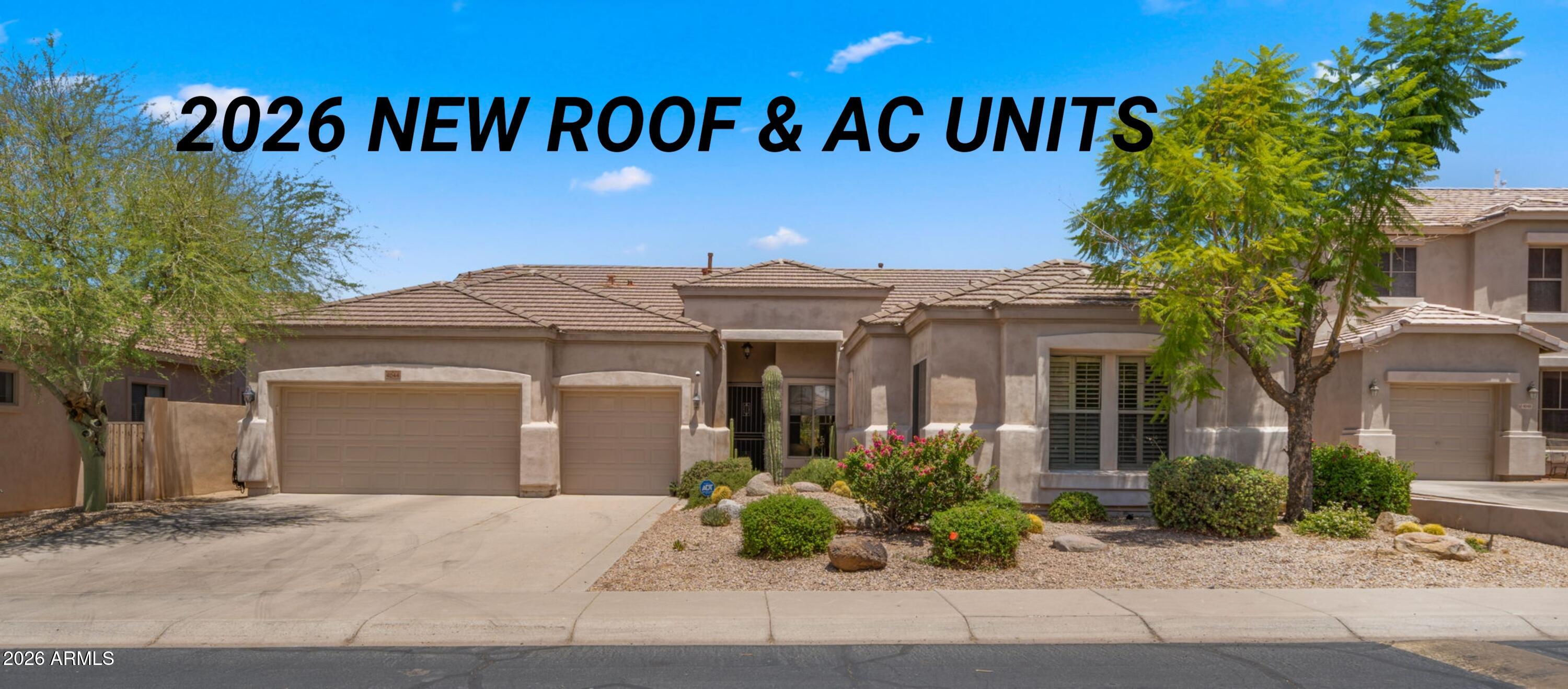 Stucco home with desert landscaping; overlay reads “2026 New Roof & AC Units.”