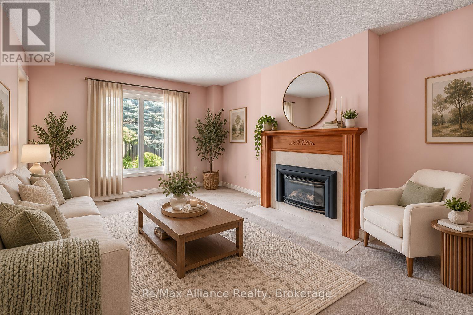Furnished living room with pink walls, a wood-trimmed fireplace, and large curtained window.
