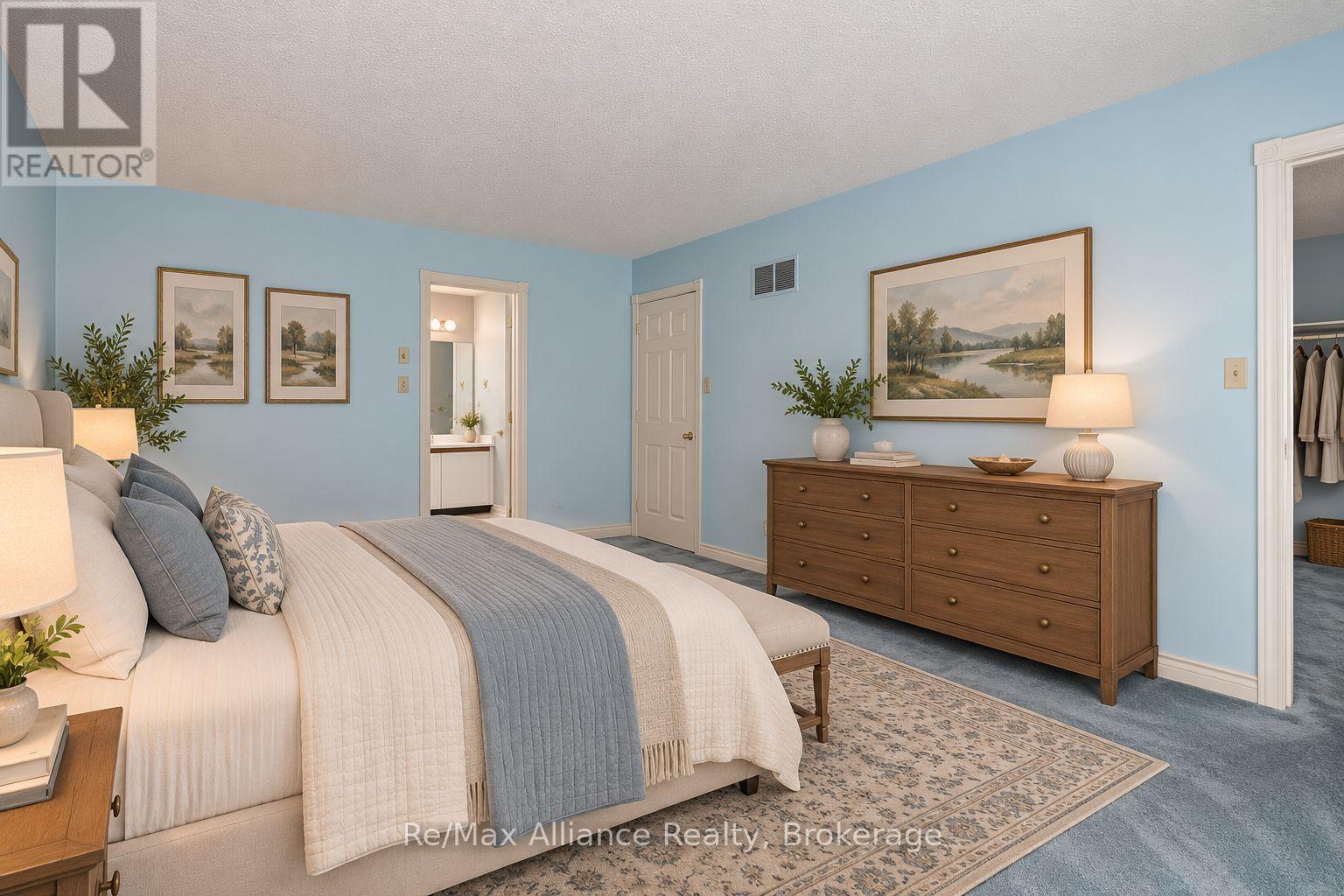 Furnished bedroom with a white-and-blue bed, pale blue walls, and a long wooden dresser.