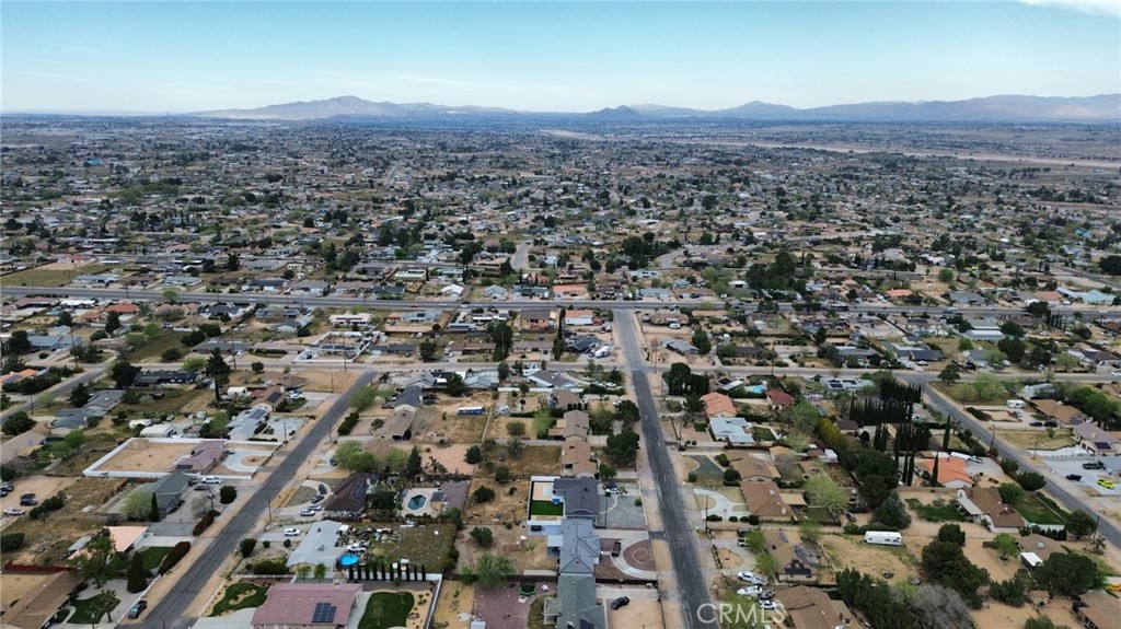 Aerial view of Hesperia homes and streets, with distant mountains on the horizon.