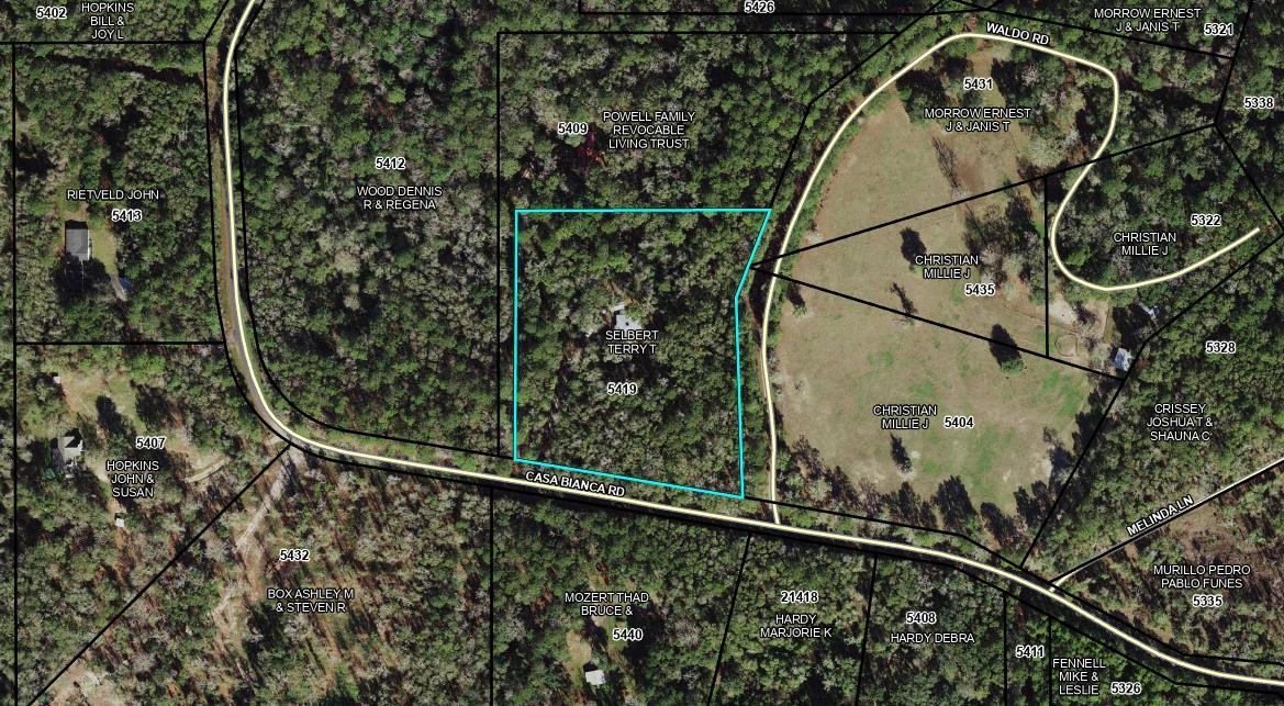 Aerial parcel map highlighting the wooded lot at 5419 Casa Bianca Road in cyan.