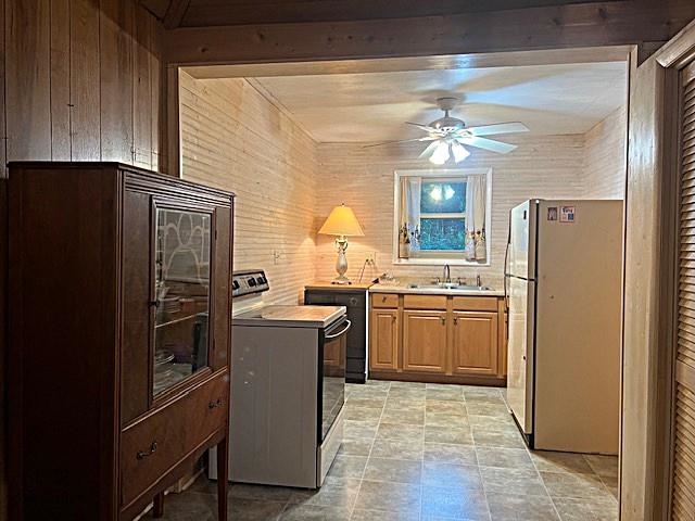 Kitchen with light wood cabinets, tiled floor, and a dark glass-front cabinet in the foreground.