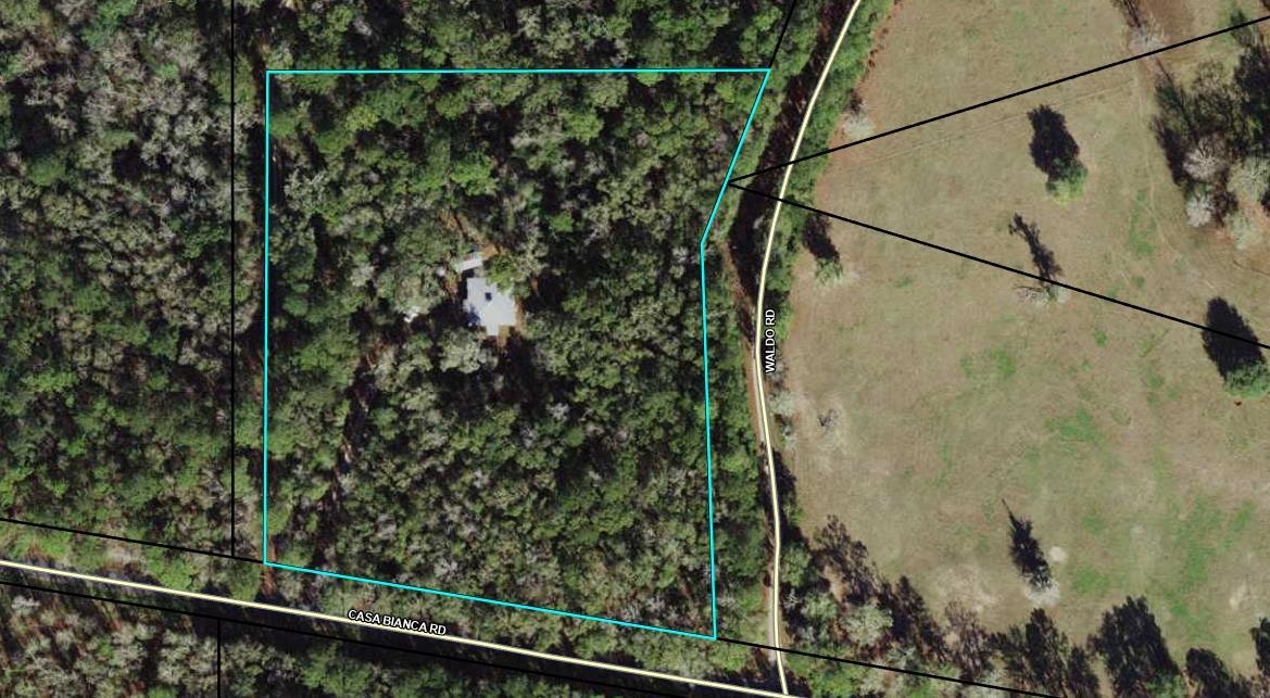 Wooded property outlined beside Casa Bianca Road and Waldo Road, with a small house near the center.