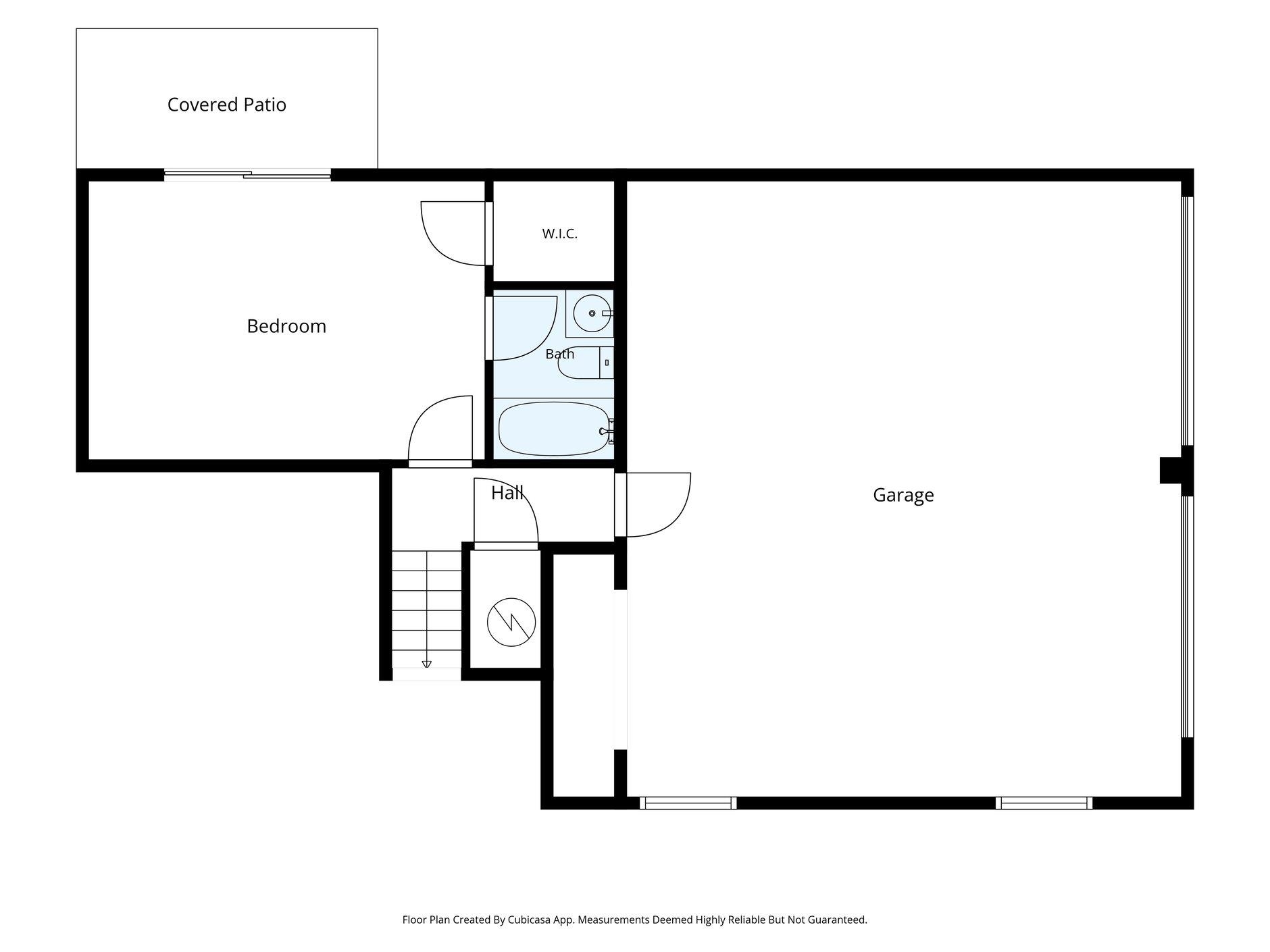 Floor plan with a bedroom, bath, covered patio, and large garage.