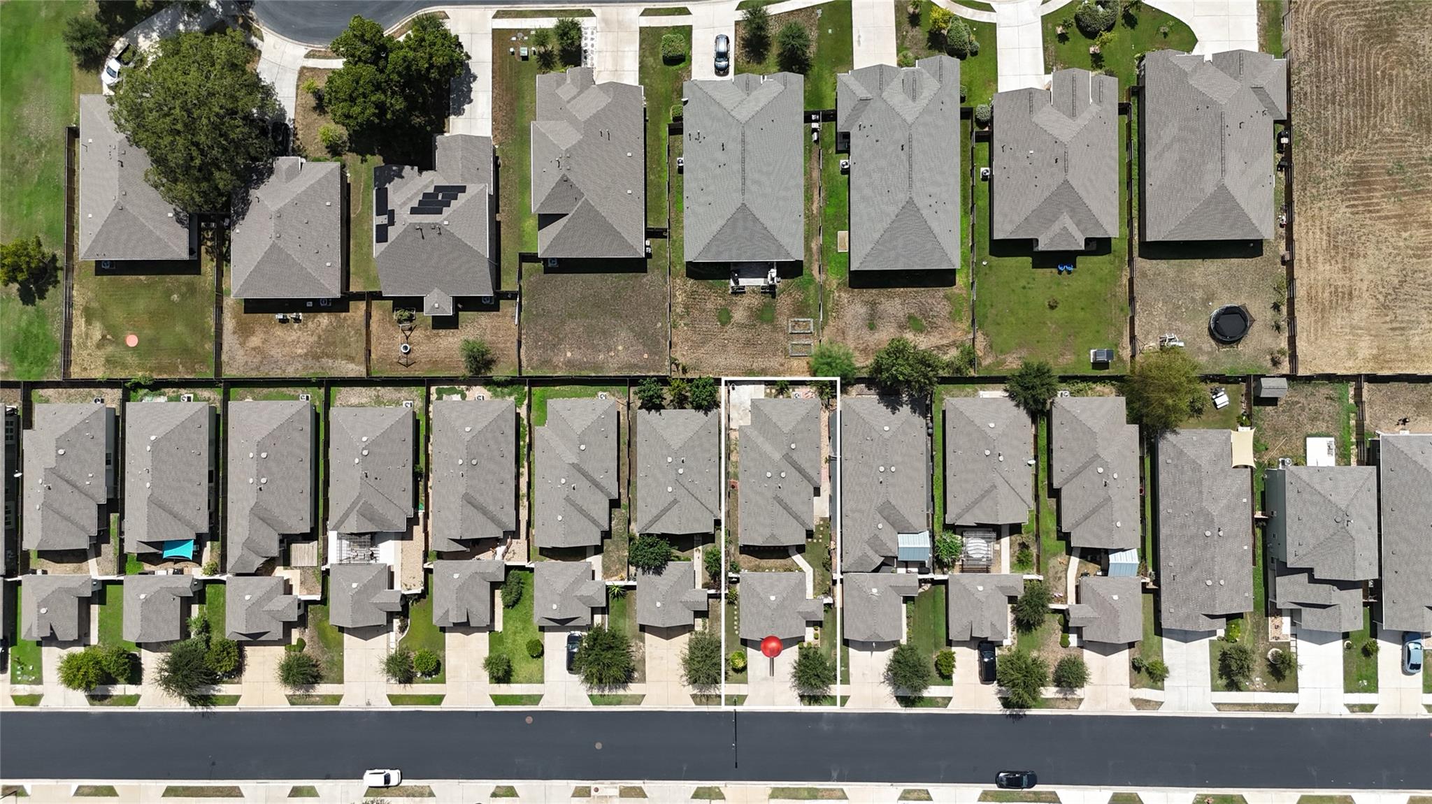 Aerial view of 118 Trailstone Drive outlined among neighboring homes along a residential street.