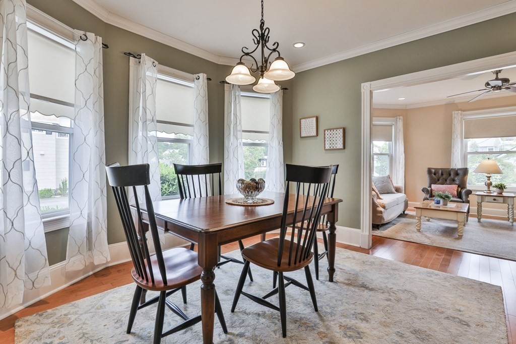 Dining room with a dark wood table, black chairs, and a doorway to the living room.