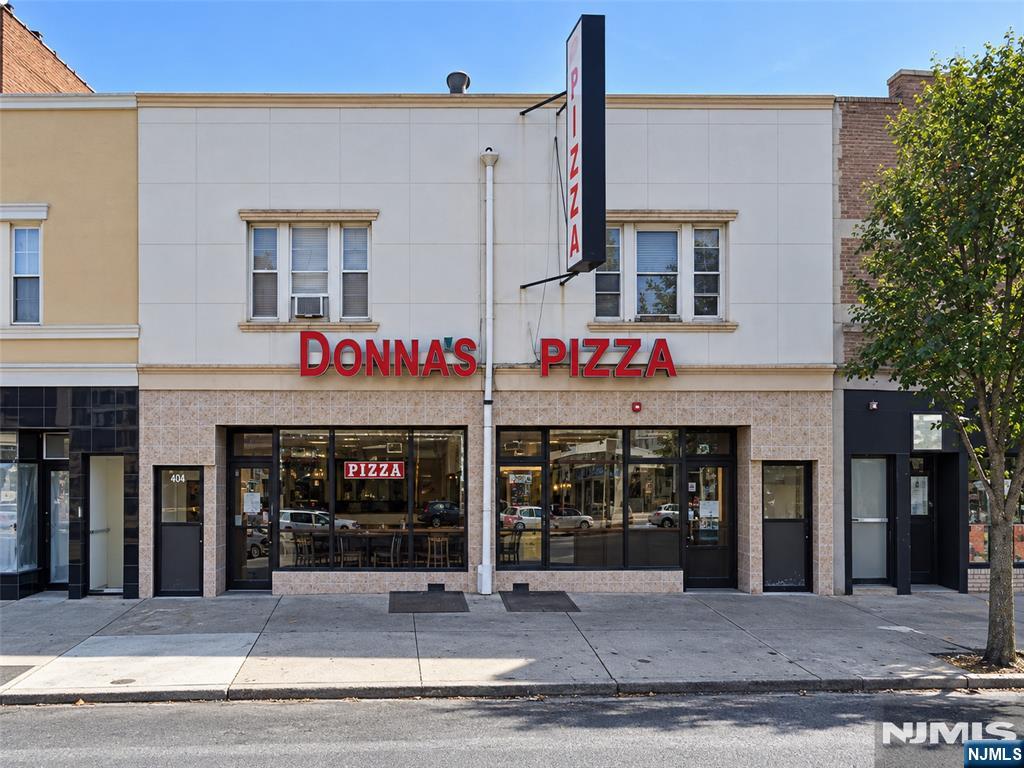 Commercial storefront at 404 Broad Avenue with Donna’s Pizza signage and large street-facing windows.