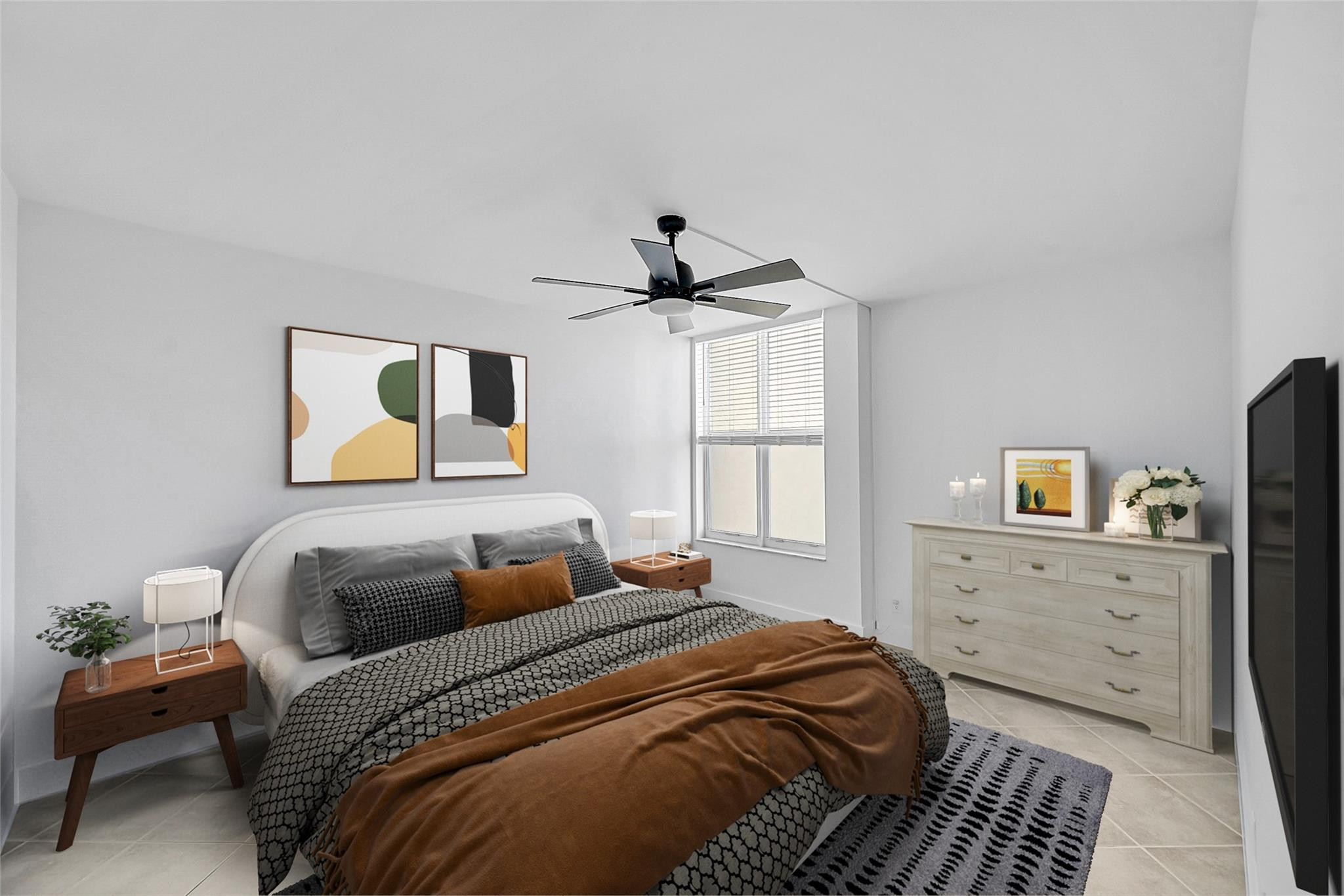 Staged bedroom with patterned bedding, a rust-brown throw, abstract wall art, and a white dresser.