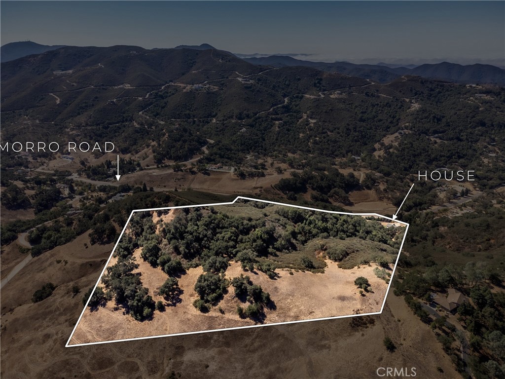Aerial view of a wooded rural parcel outlined near Morro Road, with the house marked.