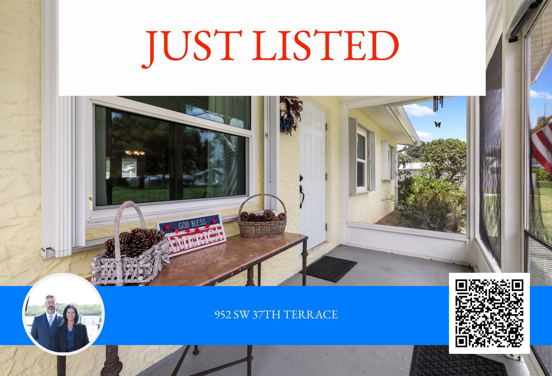 Home’s screened front porch with a white entry door, pale yellow walls, and a console table.