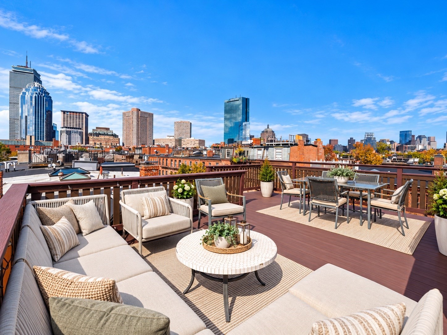 Furnished rooftop deck with lounge seating and Boston skyline views.