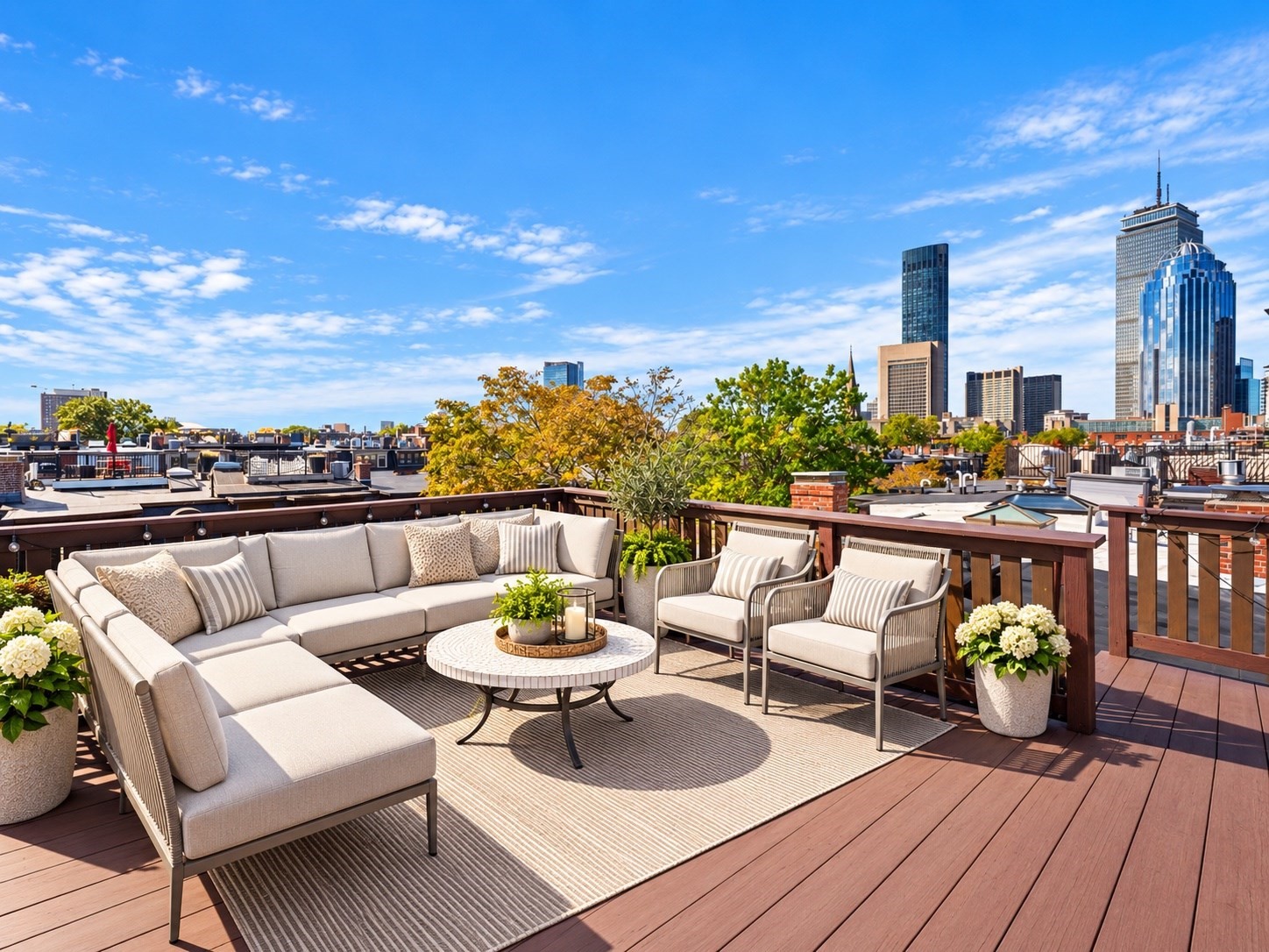 Furnished rooftop deck with lounge seating and a city skyline view.